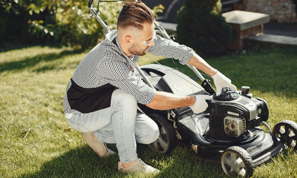 Man fixing a lawn mower.