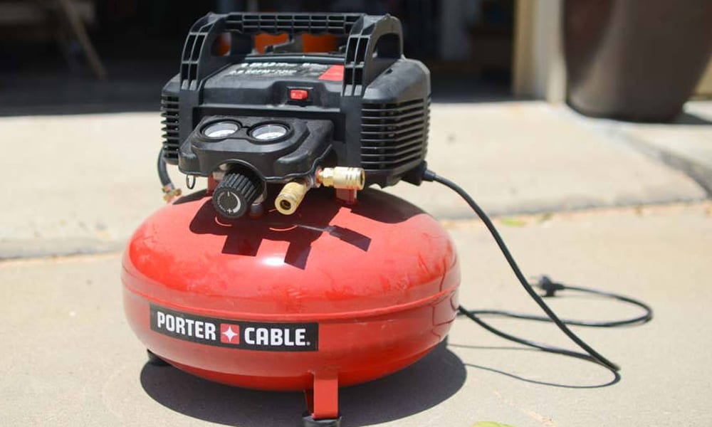 air compressor sitting a a concrete floor