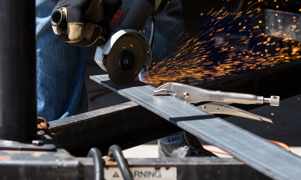 angle grinder cutting through metal strip