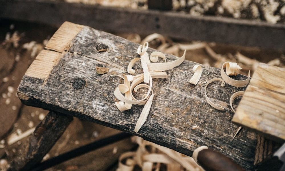 wood shavings all over a wooden stool