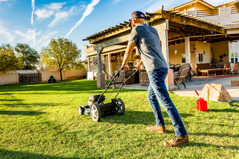 Man using a gas push mower