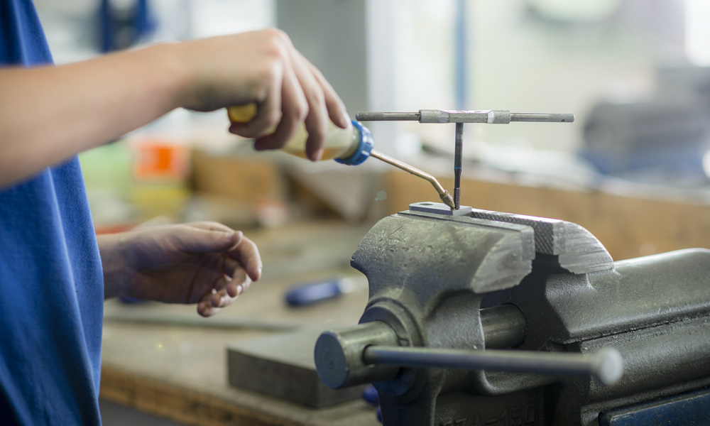 A man using a bench vise