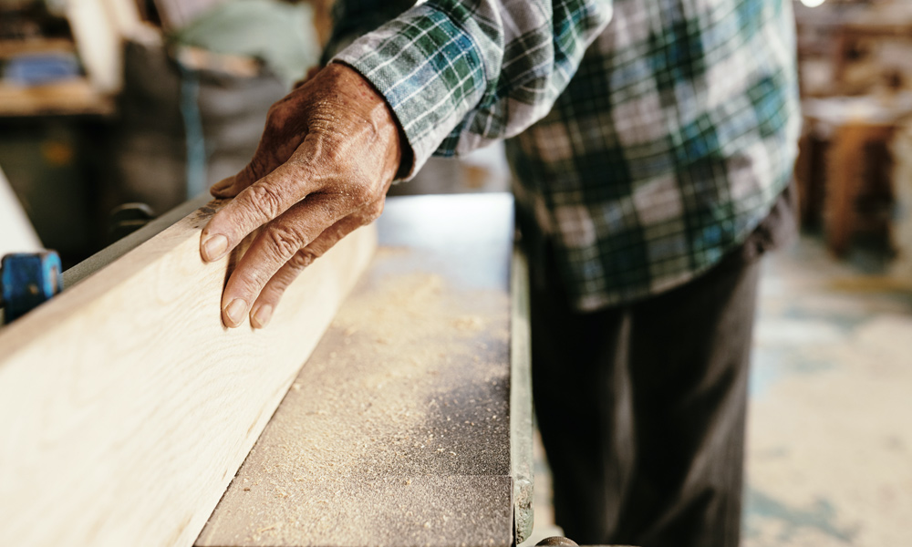 a work person using a benchtop jointers