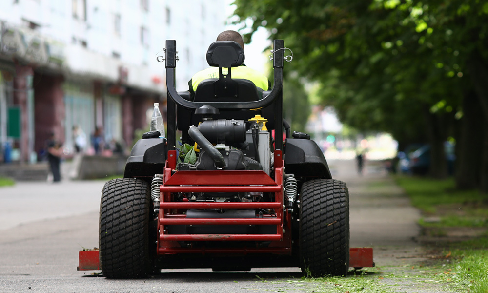 Zero turn mower riding down the road