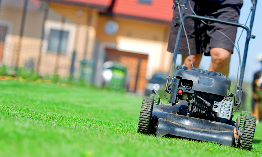 grey lawn mower cutting grass