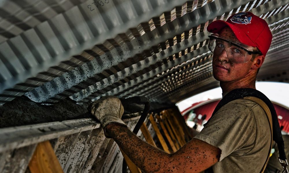 a worker wearing safety glasses and gloves.