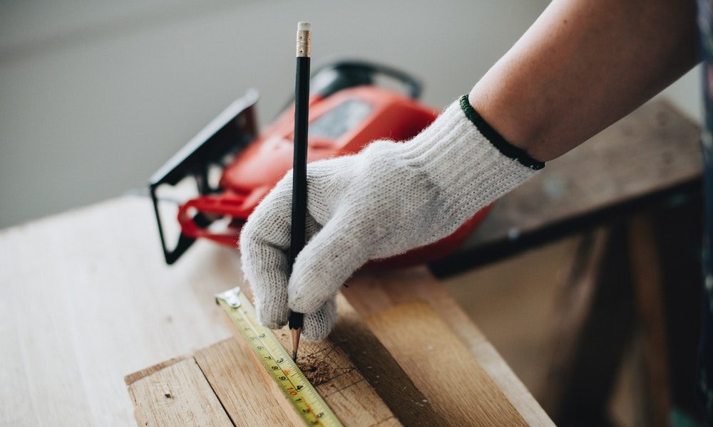 a work person using a tape measure 