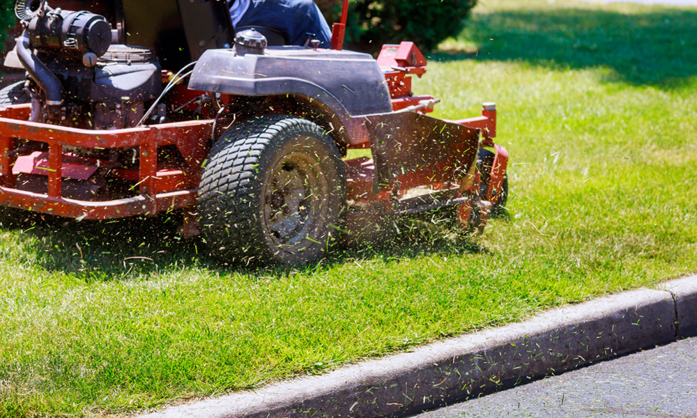 Zero turn mower kicking up grass clippings