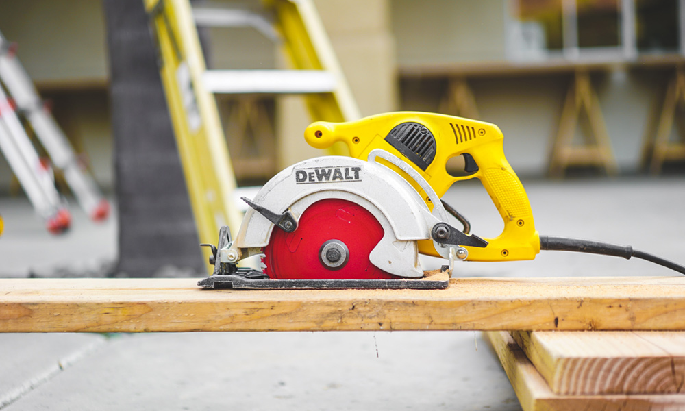 cordless circular saw resting on a plank of wood