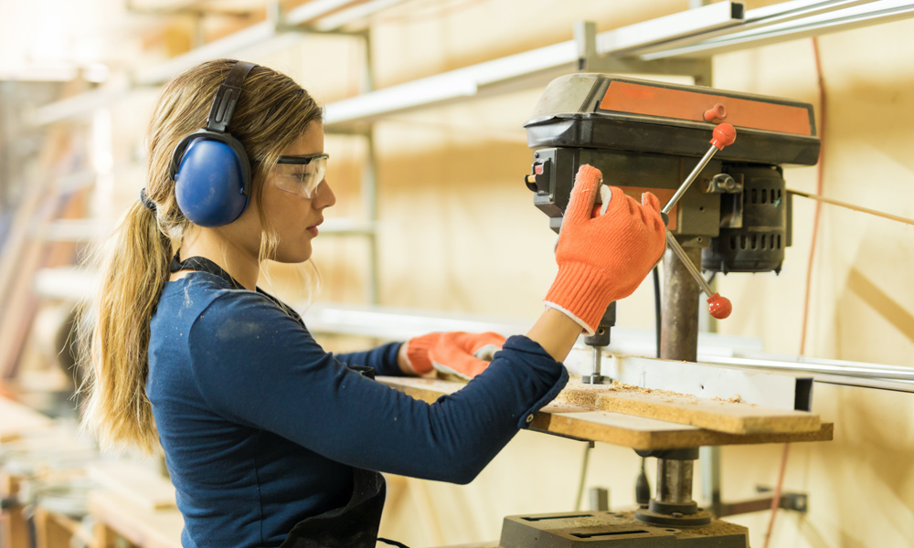 A woman using a Benchtop Drill Press