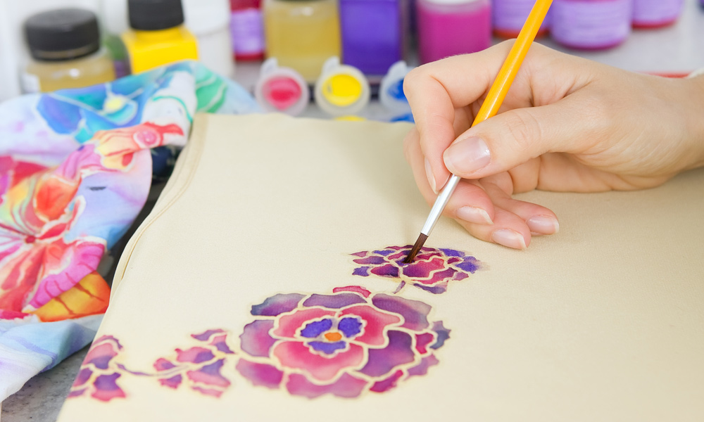 A painting of a flower on fabric