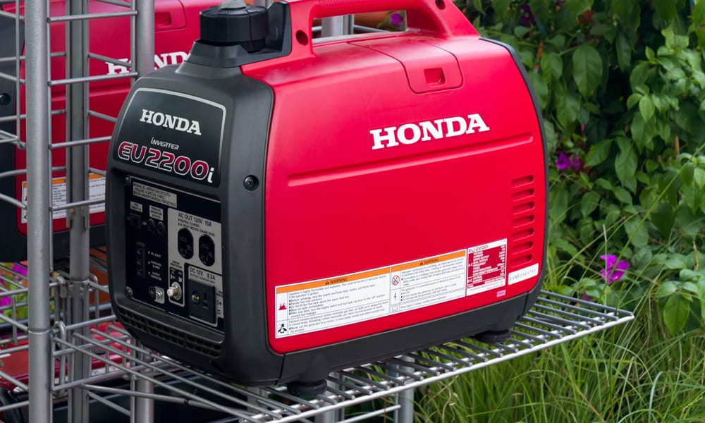 A inverter generator sitting on a metal cage