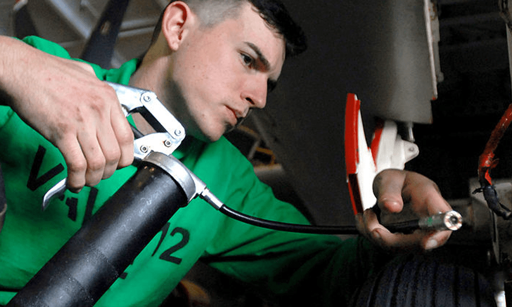 A man holding a grease gun