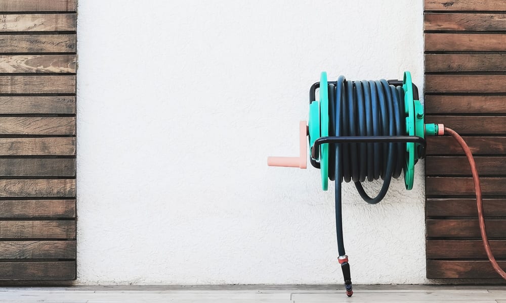 wall mounted hose reel on a white wall