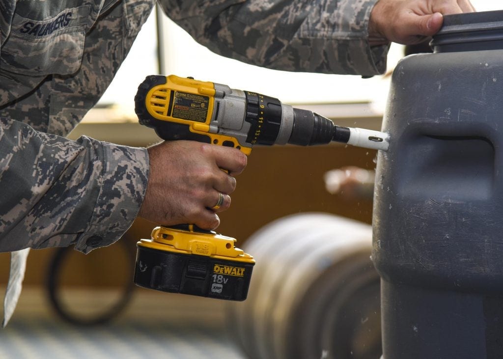 cordless Dewalt drill being used 