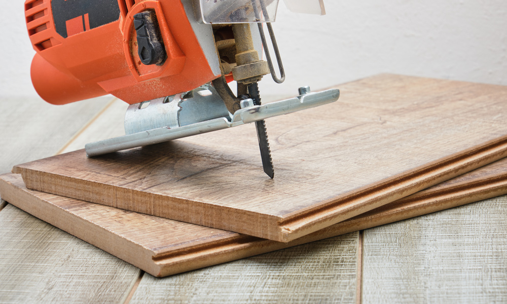 Jigsaw sitting on top of laminate flooring