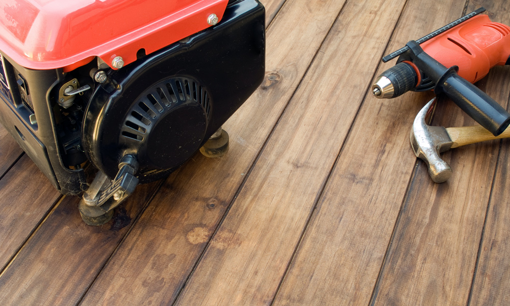 generator sitting on a deck with power tools next to it