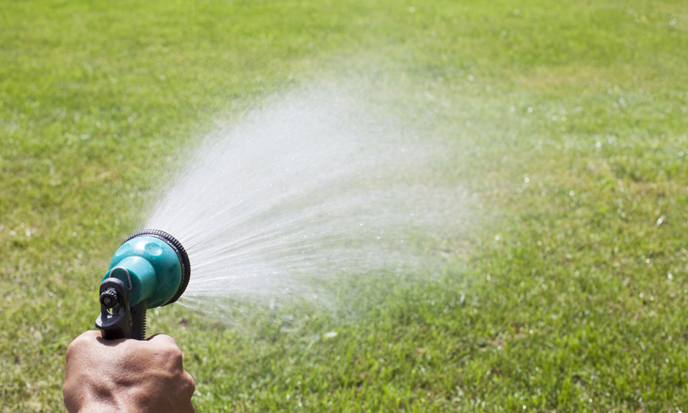 garden spray gun watering grass