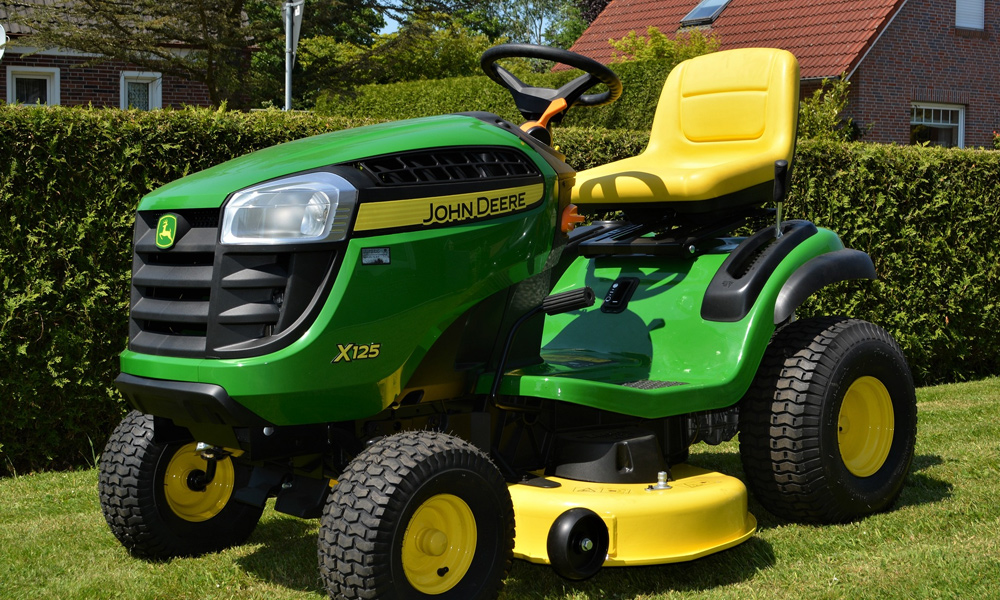 John deere riding lawn mower on green grass