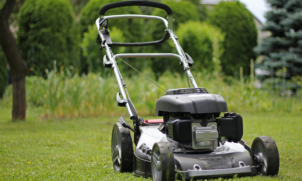 Silver lawn mower on grass