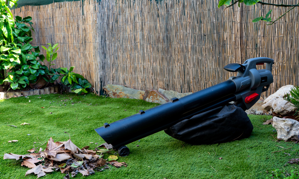 Green & black leaf blower in a garden