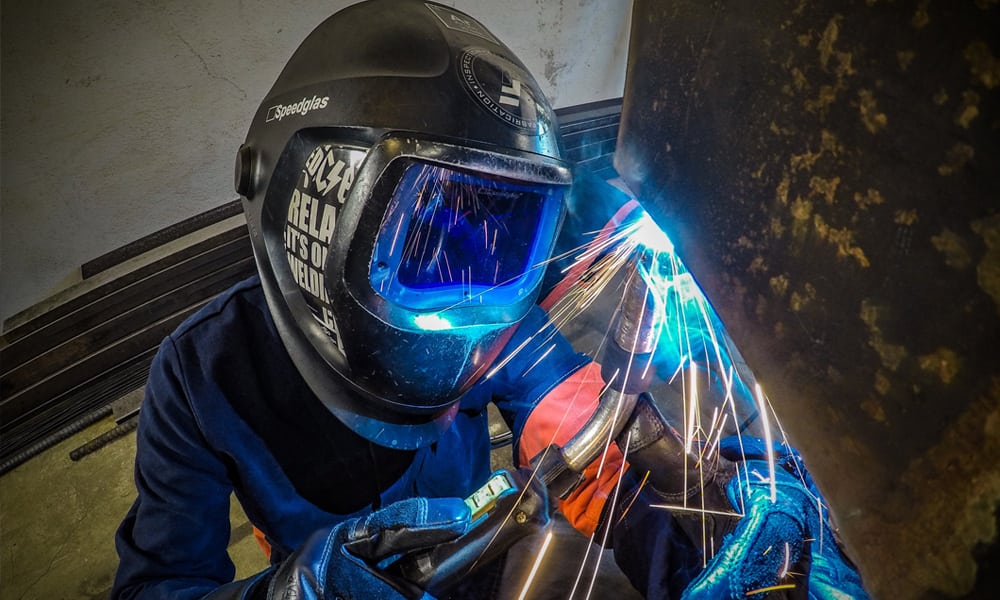 A person wearing a welding mask while welding