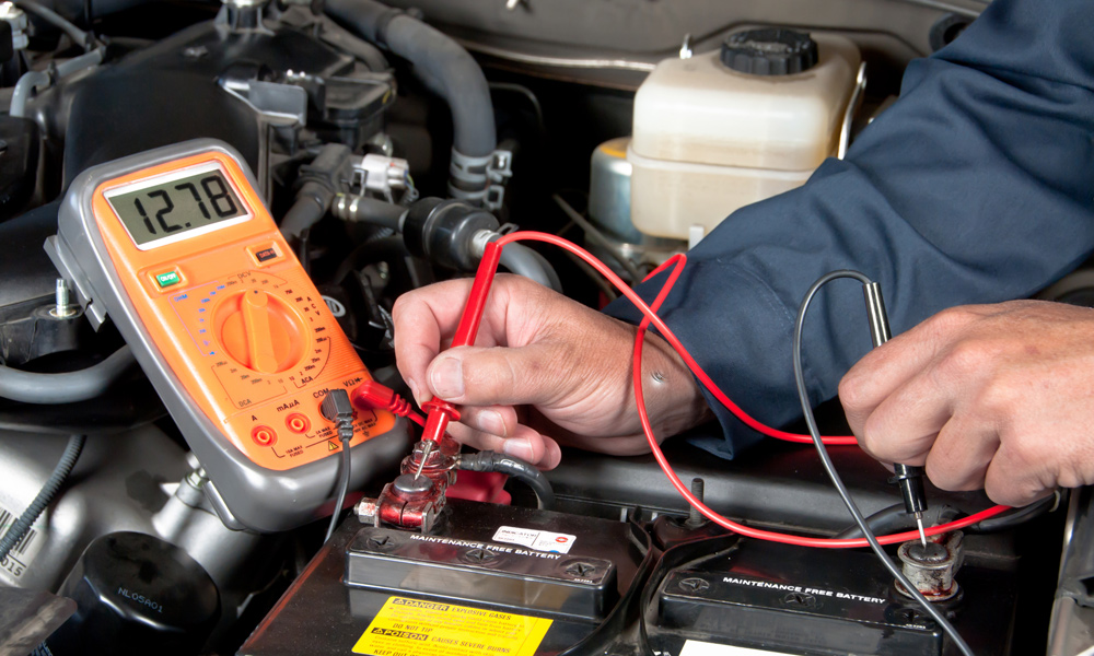 Multimeter testing a car battery