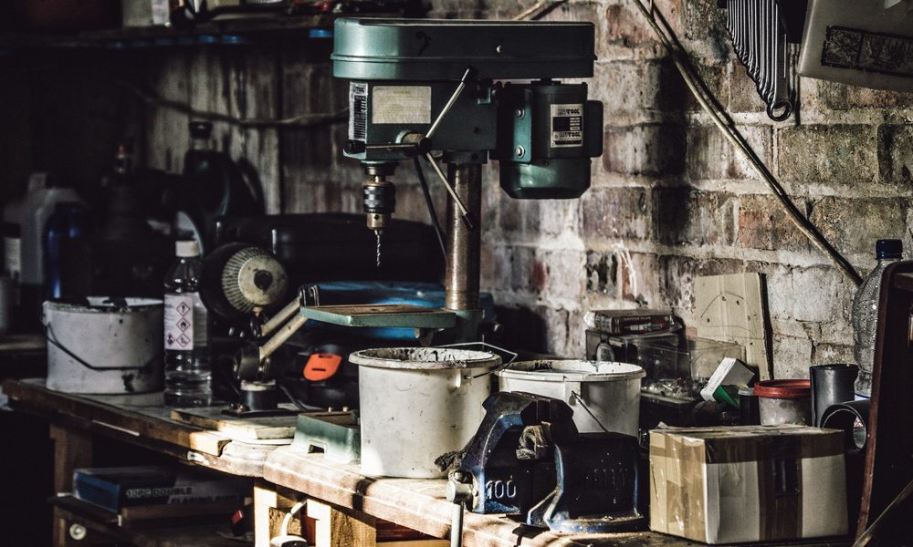 A benchtop Drill Press in a garage