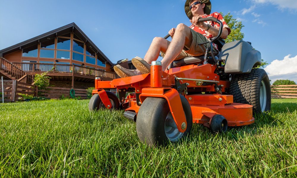 man using a zero turn mower 