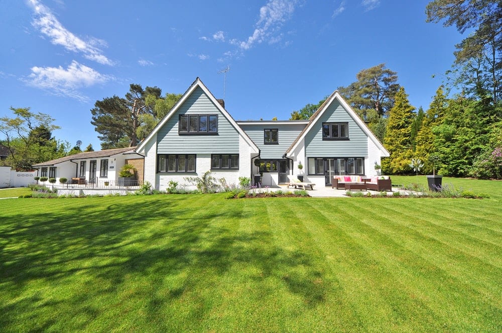 A house with a garden with fresh cut lawn stripes