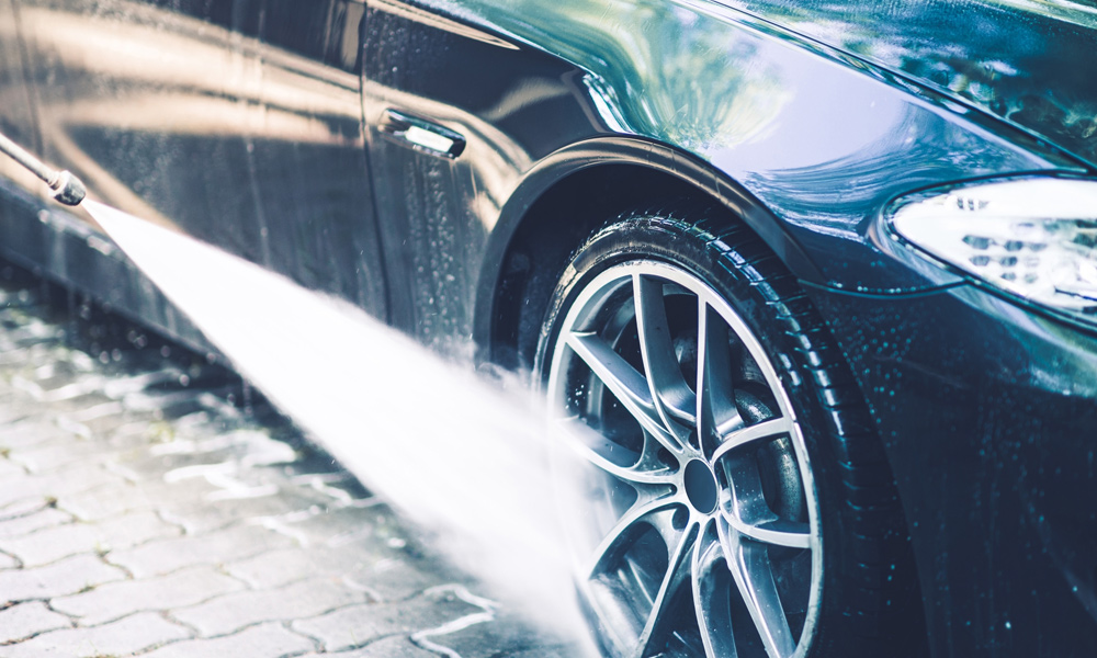 jet wash gun cleaning a car alloy wheel