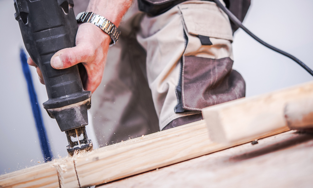 reciprocating saw cutting through wood