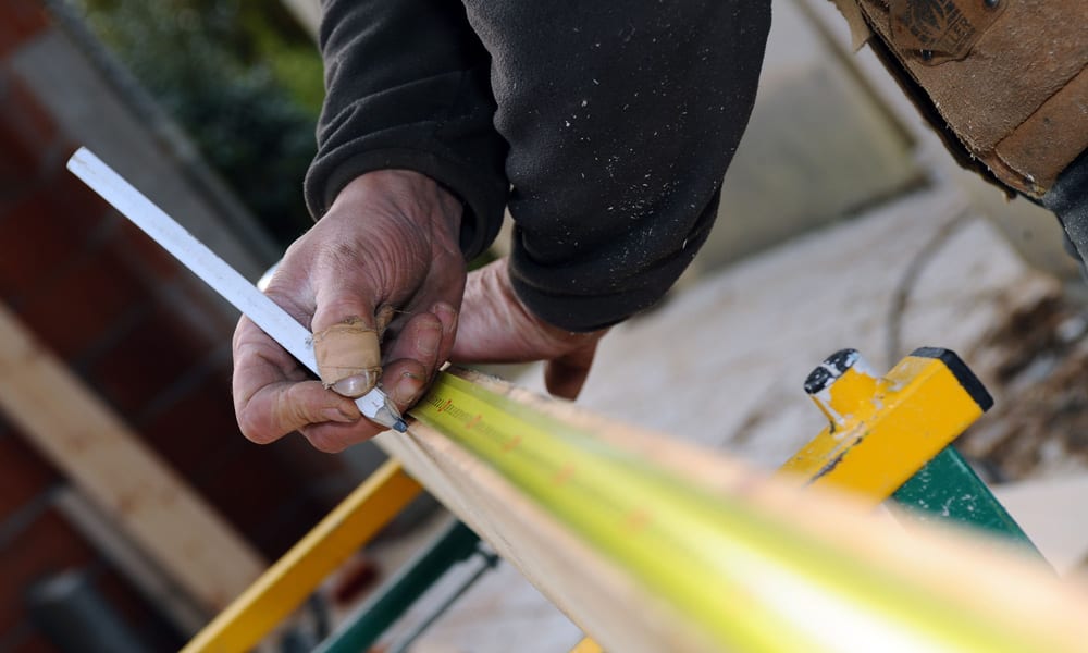 measuring a piece of wood on a Saw Horse