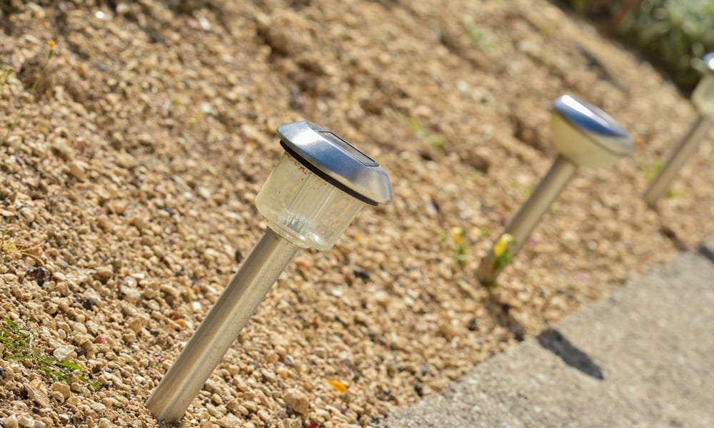 solar lights in a line in gravel