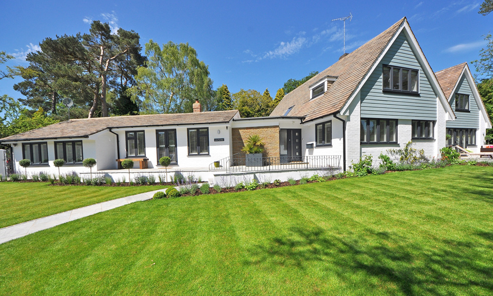 big house with lawn stripes in the grass