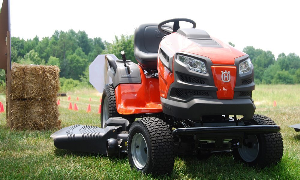 A red husqvarna riding lawn mower