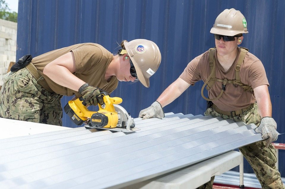 Two workman using a miter saw