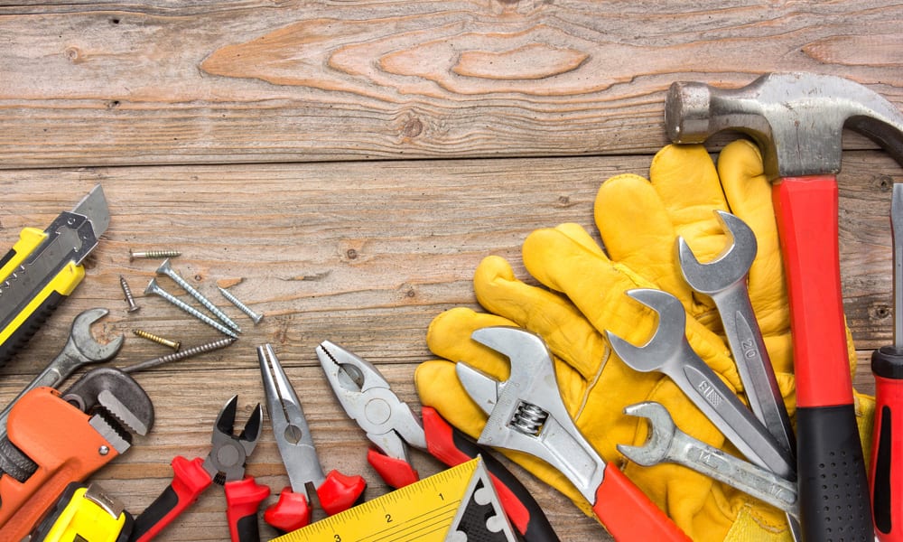 different types of tools and screws laying on the floor in a row