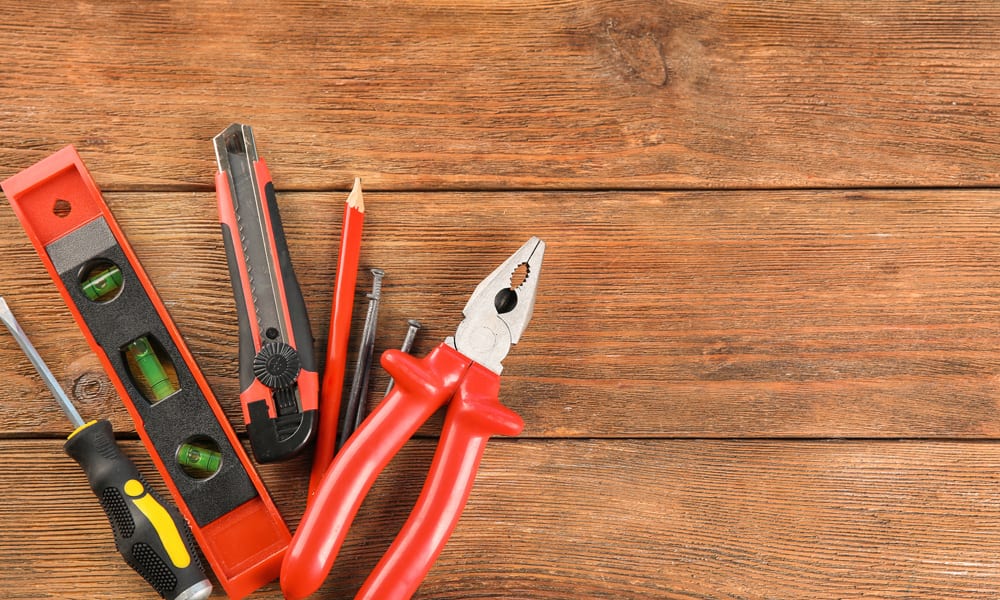 different types of tools laying on wood flooring