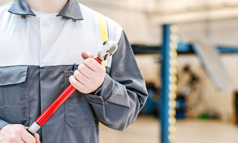 a mechanic holding a Torque Wrench