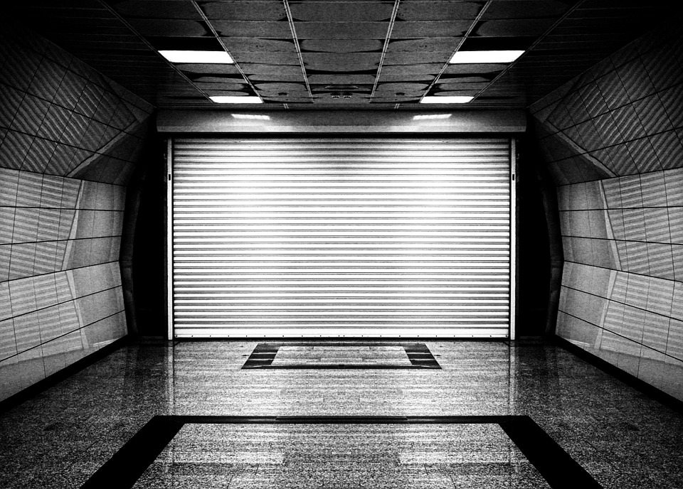 A garage with a white roller shutters