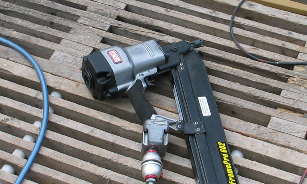 Nail Gun laying down on wood flooring