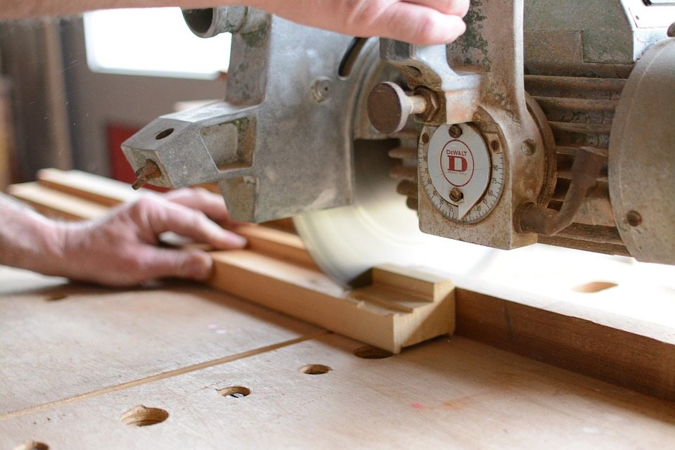 Compound miter saw cutting through wood