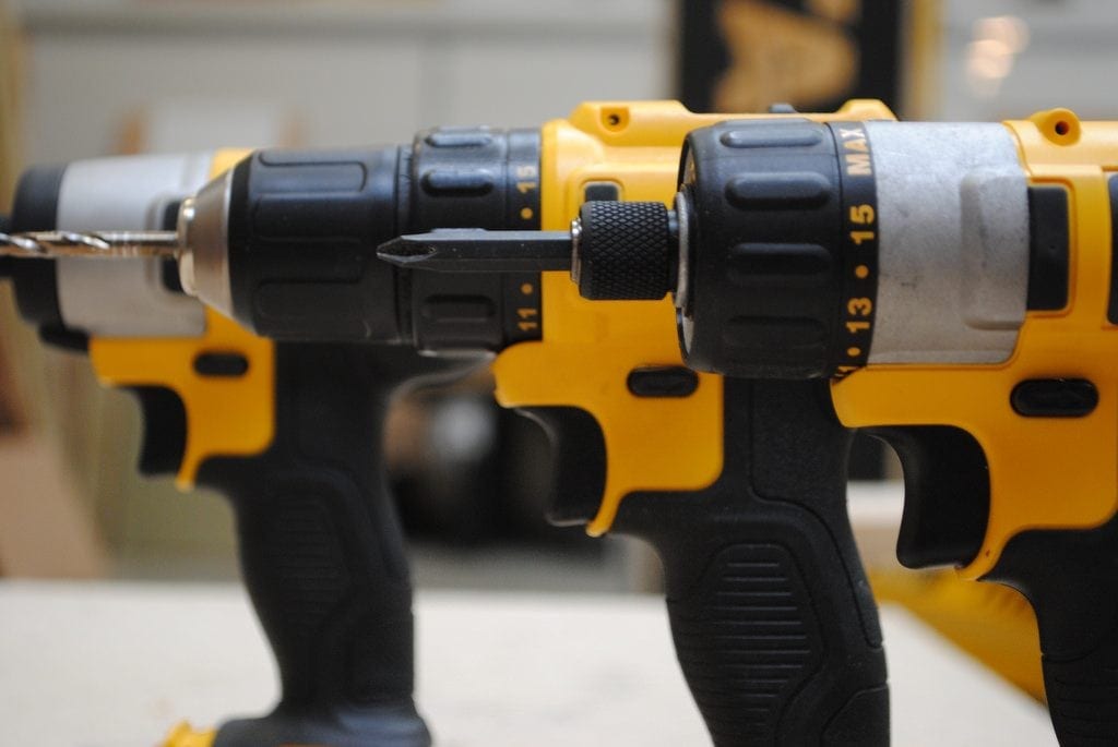 close up of three dewalt drills in a line