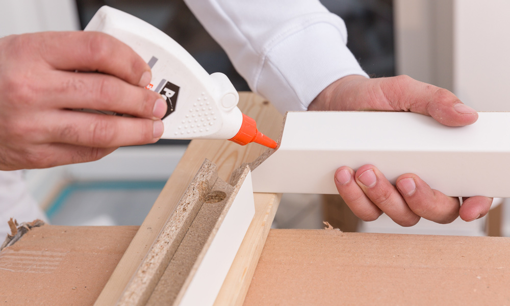 glue bottle applying glue to wood