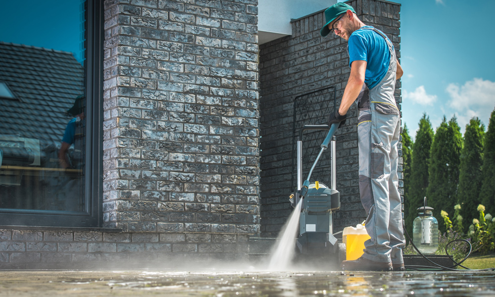 work person using a pressure washer